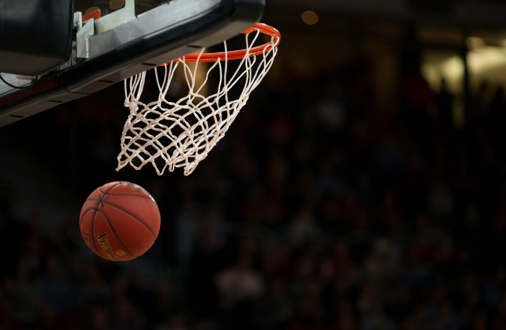 Photo of basketball going through hoop. Athlete financing helps score financial wins.
